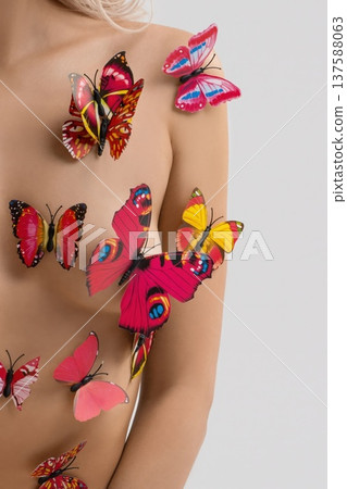 Colorful butterflies on skin create a visual display of nature and art during a studio session in bright lighting Colorful butterflies on skin create a visual display of nature and art during a studio session in bright lighting 137588063