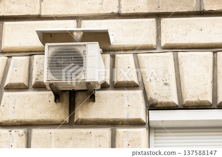 air conditioning on facade of building, air cooling in hot weather. air conditioning on facade of building, air cooling in hot weather. 137588147