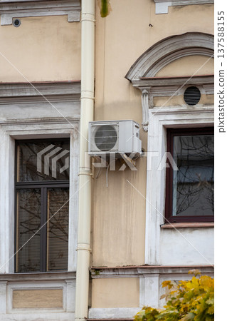 air conditioning on facade of building, air cooling in hot weather. air conditioning on facade of building, air cooling in hot weather. 137588155