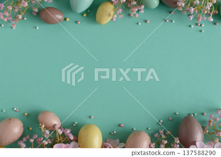 Pastel Easter Eggs and Flowers on Teal Background. Festive Spring Flatlay 137588290