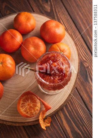 Fresh Tangerines with Jam Glass on wooden Background. Rustic Gourmet Composition Fresh Tangerines with Jam Glass on wooden Background. Rustic Gourmet Composition 137588311
