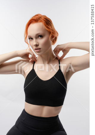 Elegant woman poses in artistic light projection with a confident expression Elegant woman poses in artistic light projection with a confident expression 137588415