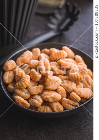 Rustic tomato Gnocchi in Bowl Ready to Cook Comforting Italian Pasta Dish Rustic tomato Gnocchi in Bowl Ready to Cook Comforting Italian Pasta Dish 137589535