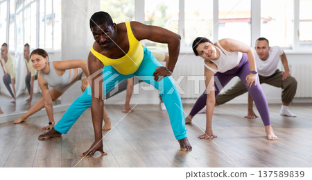 Middle-aged Afro-American man practicing aerobic dance in training hall 137589839