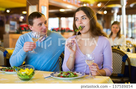 Couple chatting while having dinner in restaurant 137589854