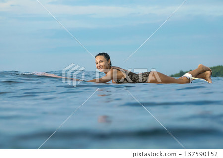 Smiling Young Lady Engaged In Peaceful Paddle As Sunrise Gently Lights Water Smiling Young Lady Engaged In Peaceful Paddle As Sunrise Gently Lights Water 137590152