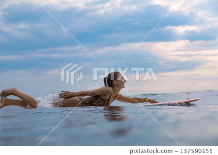Tranquil Maiden Attentively Paddling On Surfboard Amidst Verdant Beach Landscape Tranquil Maiden Attentively Paddling On Surfboard Amidst Verdant Beach Landscape 137590155