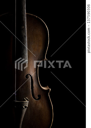 Elegant close-up of a wooden violin in shadow highlighting its beautiful contours and craftsmanship 137590306