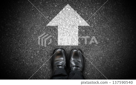 Black business shoes and chalky arrow on asphalt - forward concept Black business shoes and chalky arrow on asphalt - forward concept 137590540