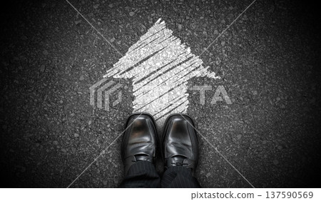 Black business shoes and chalky arrow on asphalt - forward concept 137590569