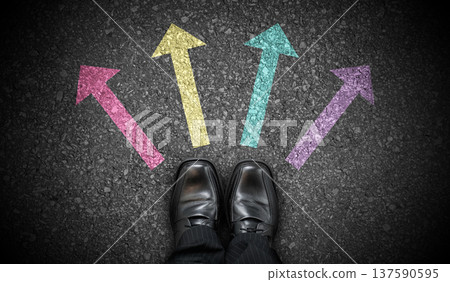 Black business shoes and colorful four chalky arrows on asphalt - direction concept 137590595