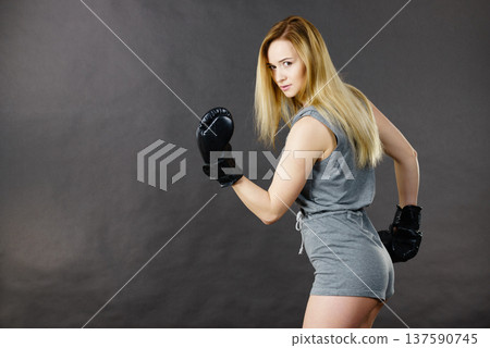 Boxer girl exercise with boxing gloves. Boxer girl exercise with boxing gloves. 137590745