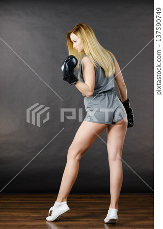 Boxer girl exercise with boxing gloves. Boxer girl exercise with boxing gloves. 137590749