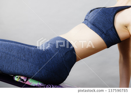 Woman training on bench for sit ups Woman training on bench for sit ups 137590785