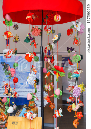 Sakata, Yamagata, Japan - Oct 5 2024, vertical view of small handmade toys suspended on strings like garlands, Sakata, Japan Sakata, Yamagata, Japan - Oct 5 2024, vertical view of small handmade toys suspended on strings like garlands, Sakata, Japan 137590989