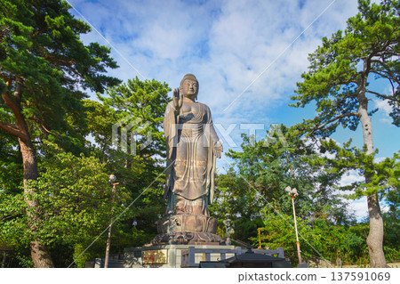 Sakata, Yamagata, japan - Oct 5 2024, A panoramic view of the giant Great Buddha statue at Jichi-In Temple, with trees in the background, at daytime, Sakata, Japan Sakata, Yamagata, japan - Oct 5 2024, A panoramic view of the giant Great Buddha statue at Jichi-In Temple, with trees in the background, at daytime, Sakata, Japan 137591069