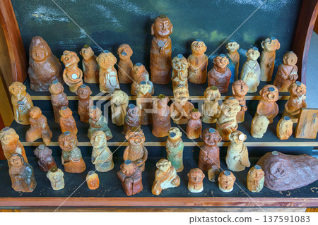 Sakata, Yamagata, japan - Oct 5 2024, Klous ap ivd on a stand with small terracotta figurines in the form of people, each with a coin on their forehead, in the temple, Sakata, Japan 137591083