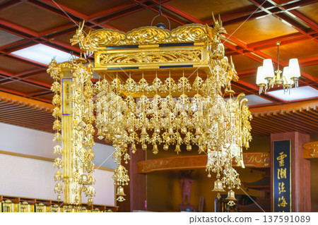 Sakata, Yamagata, japan - Oct 5 2024, A panoramic view of a gilded lamp suspended from the ceiling with many small decorative elements, part of the main altar of the Jichi-in Temple, Sakata, Japan Sakata, Yamagata, japan - Oct 5 2024, A panoramic view of a gilded lamp suspended from the ceiling with many small decorative elements, part of the main altar of the Jichi-in Temple, Sakata, Japan 137591089