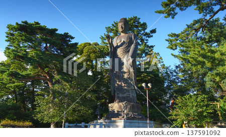 Sakata, Yamagata, japan - Oct 5 2024, A panoramic view of the giant Great Buddha statue at Jichi-In Temple, with trees in the background, at daytime, Sakata, Japan Sakata, Yamagata, japan - Oct 5 2024, A panoramic view of the giant Great Buddha statue at Jichi-In Temple, with trees in the background, at daytime, Sakata, Japan 137591092