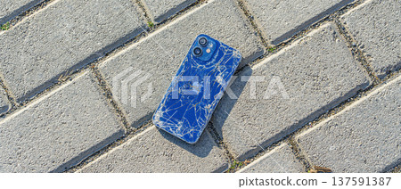 broken Apple iPhone lies on the sidewalk broken Apple iPhone lies on the sidewalk 137591387