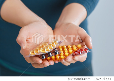 Vitamins And Supplements. Closeup Of Woman Hands Holding Variety Of Colorful Vitamin Pills. Close-up Handful Of Medication, Medicine Tablets, Capsules. Healthy Diet Nutrition Concept. High Resolution Vitamins And Supplements. Closeup Of Woman Hands Holding Variety Of Colorful Vitamin Pills. Close-up Handful Of Medication, Medicine Tablets, Capsules. Healthy Diet Nutrition Concept. High Resolution 137591554