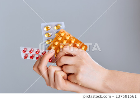 Concept Of The Global Healthcare And Medicine. Woman Holding Pack of Different Tablet Blisters Closeup. Life Save Service, Legal Drug Store, Prescribe Medication, Blood Pressure. - Image Concept Of The Global Healthcare And Medicine. Woman Holding Pack of Different Tablet Blisters Closeup. Life Save Service, Legal Drug Store, Prescribe Medication, Blood Pressure. - Image 137591561