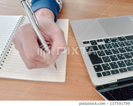 Men's hands taking notes Business image 137591799