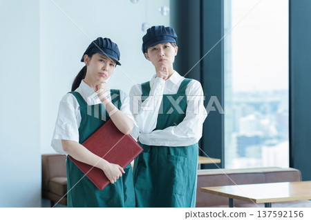 A restaurant employee thinking A restaurant employee thinking 137592156