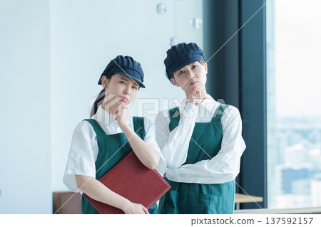 A restaurant employee thinking A restaurant employee thinking 137592157