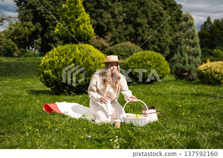 Enjoying a peaceful picnic on a sunny day in a lush green park Enjoying a peaceful picnic on a sunny day in a lush green park 137592160