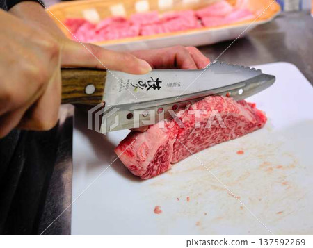 A female chef cutting domestically produced Japanese Black beef thigh meat A female chef cutting domestically produced Japanese Black beef thigh meat 137592269