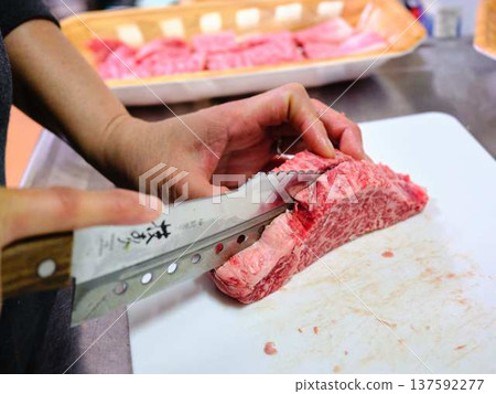 A female chef cutting domestically produced Japanese Black beef thigh meat A female chef cutting domestically produced Japanese Black beef thigh meat 137592277
