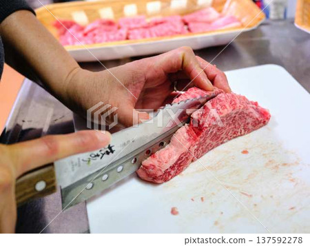 A female chef cutting domestically produced Japanese Black beef thigh meat 137592278