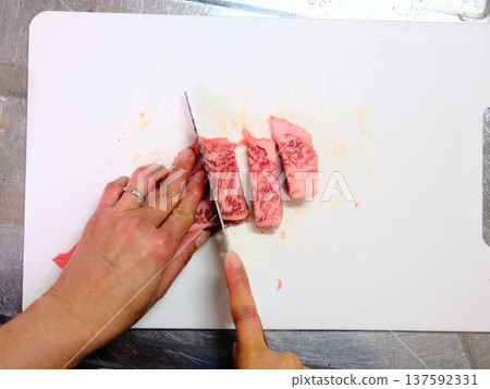 A female chef cutting domestically produced Japanese Black beef thigh meat A female chef cutting domestically produced Japanese Black beef thigh meat 137592331