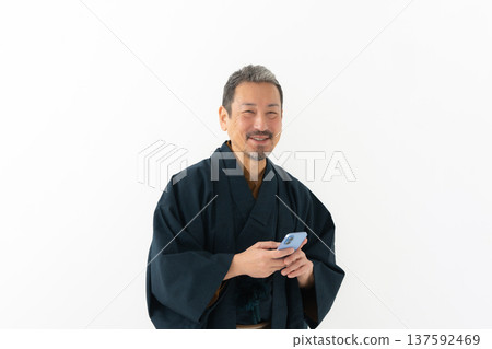 Man wearing kimono, smartphone, smartphone Man wearing kimono, smartphone, smartphone 137592469