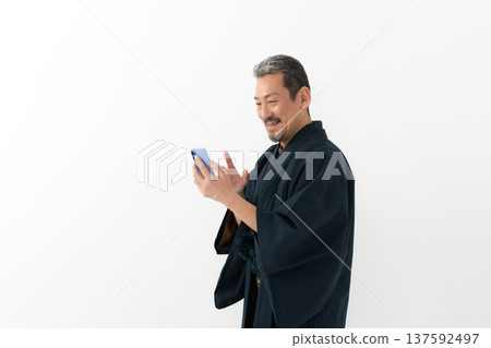 Man wearing kimono, smartphone, smartphone Man wearing kimono, smartphone, smartphone 137592497