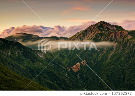 The evening light of Mount Washu and Mount Sobu seen from Sugoroku hut in the Northern Alps The evening light of Mount Washu and Mount Sobu seen from Sugoroku hut in the Northern Alps 137592572