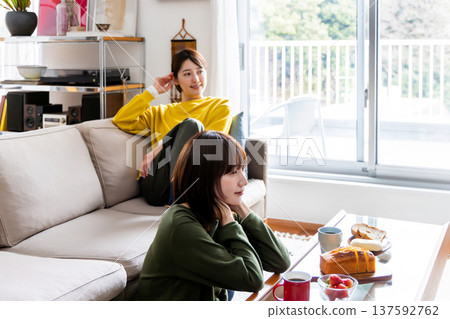 Two women watching TV together 137592762