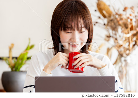 A woman taking a break from work and drinking coffee A woman taking a break from work and drinking coffee 137592810