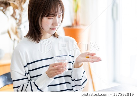 Woman taking medicine 137592819