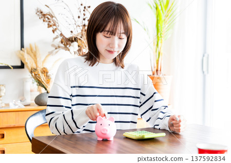 A woman saving money A woman saving money 137592834