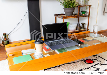 A laptop computer placed on a coffee table A laptop computer placed on a coffee table 137592904