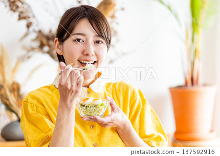 Female eating breakfast in the room 137592916