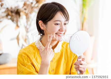 A woman pointing to a tooth A woman pointing to a tooth 137592931