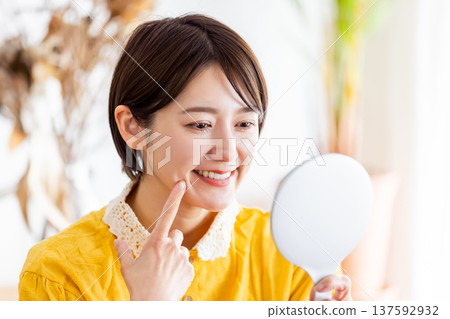 A woman pointing to a tooth A woman pointing to a tooth 137592932