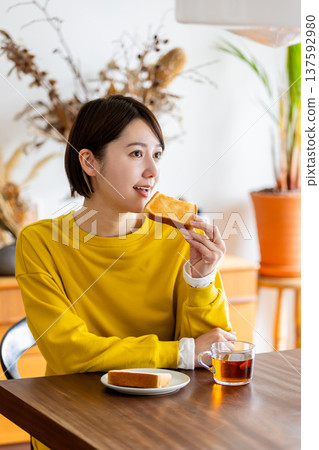 Middle woman eating breakfast 137592980