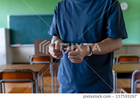 Person handcuffed in classroom 137593267