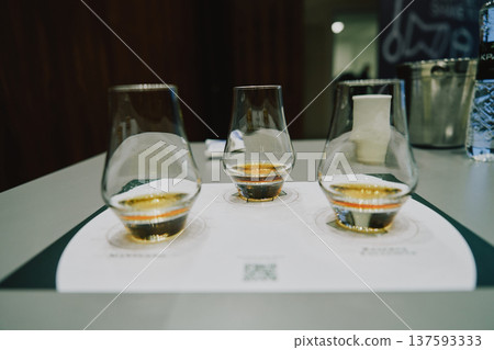 Glasses of whiskey sit on a table for tasting Glasses of whiskey sit on a table for tasting 137593333