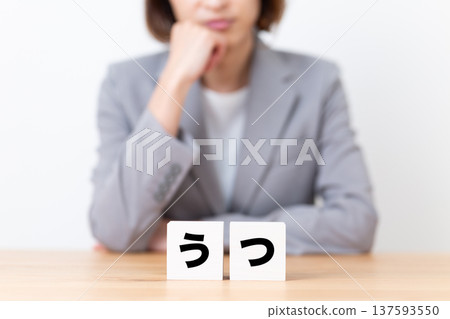 A middle-aged woman in a suit suffering from depression A middle-aged woman in a suit suffering from depression 137593550