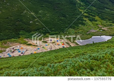 Sugoroku Pond and campsite seen from the ridge of Mt. Sugoroku Sugoroku Pond and campsite seen from the ridge of Mt. Sugoroku 137593770